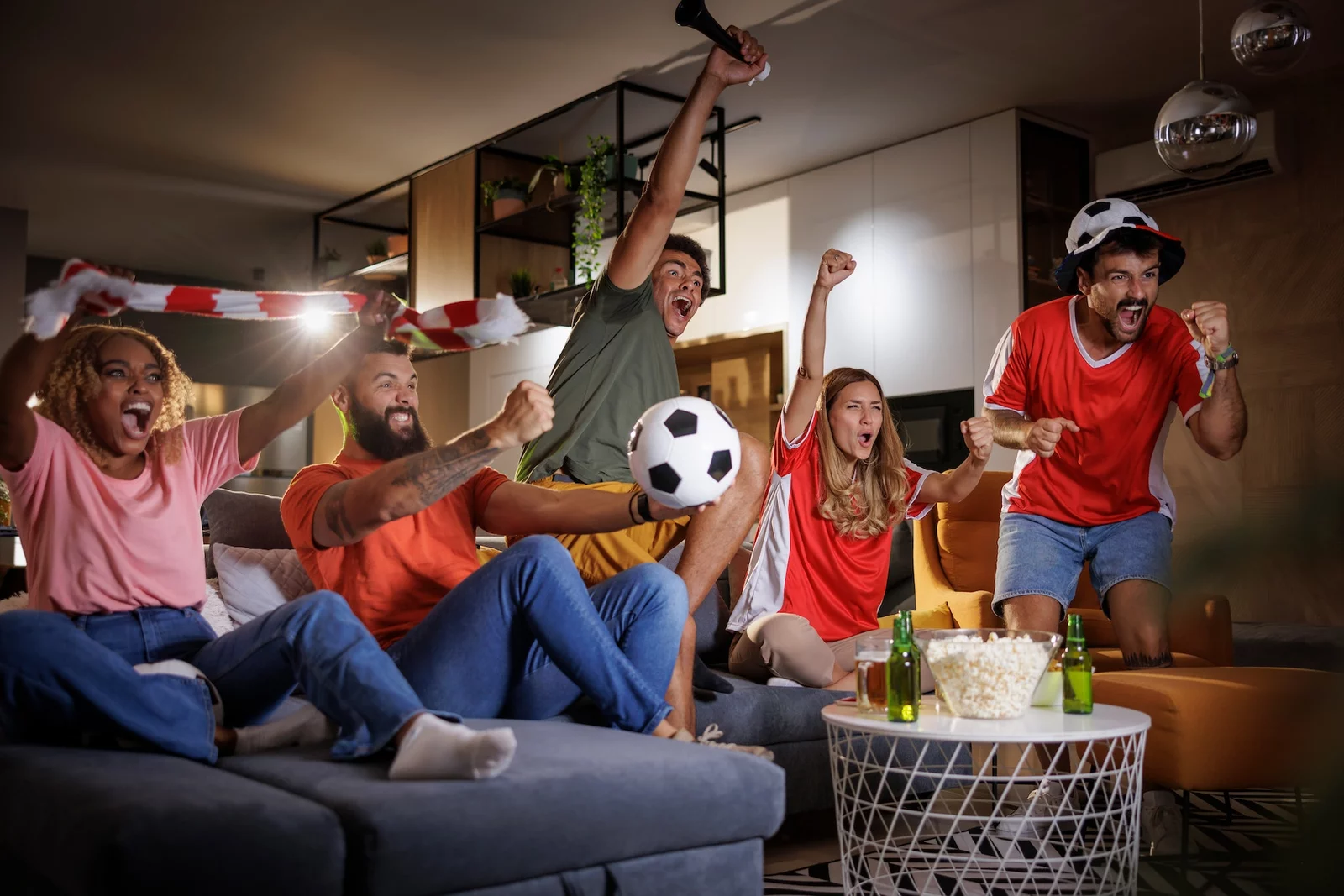 friends watching football celebrating their team victory - Unleash Infinite Entertainment: Your Premium IPTV Destination!